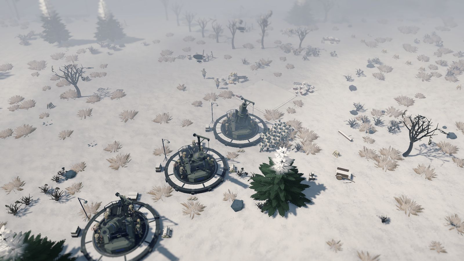 Three siege howitzers in round emplacements on snowy ground